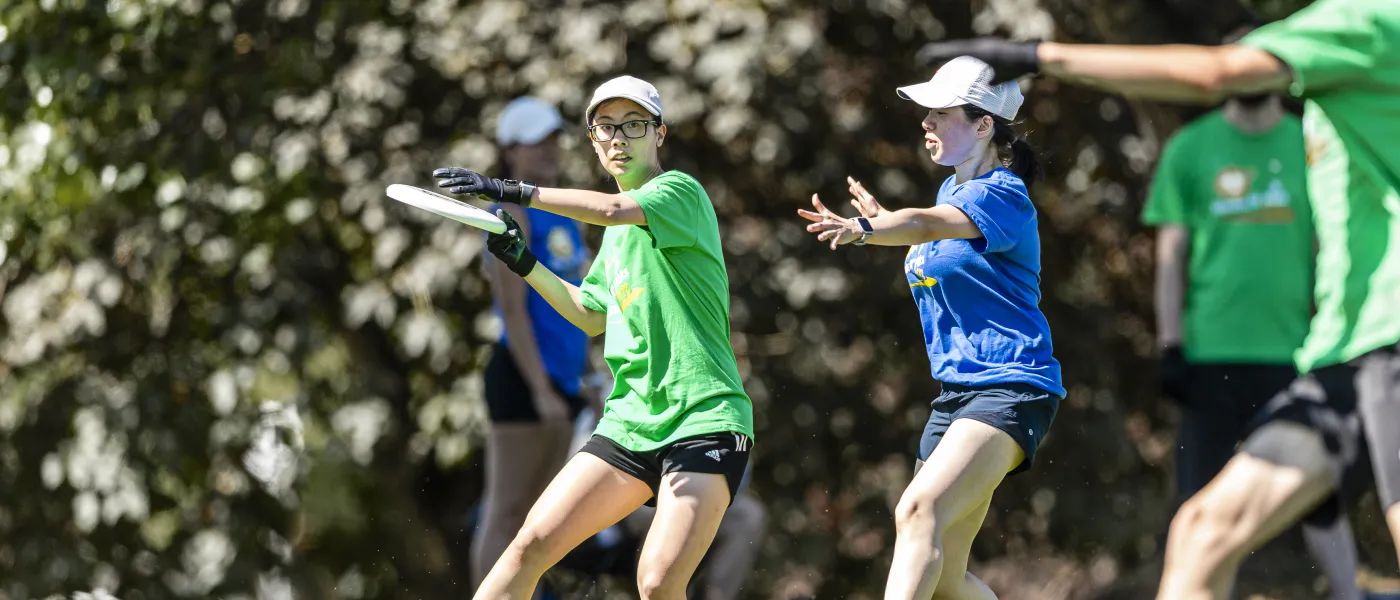 a player in green ready to throw a disc